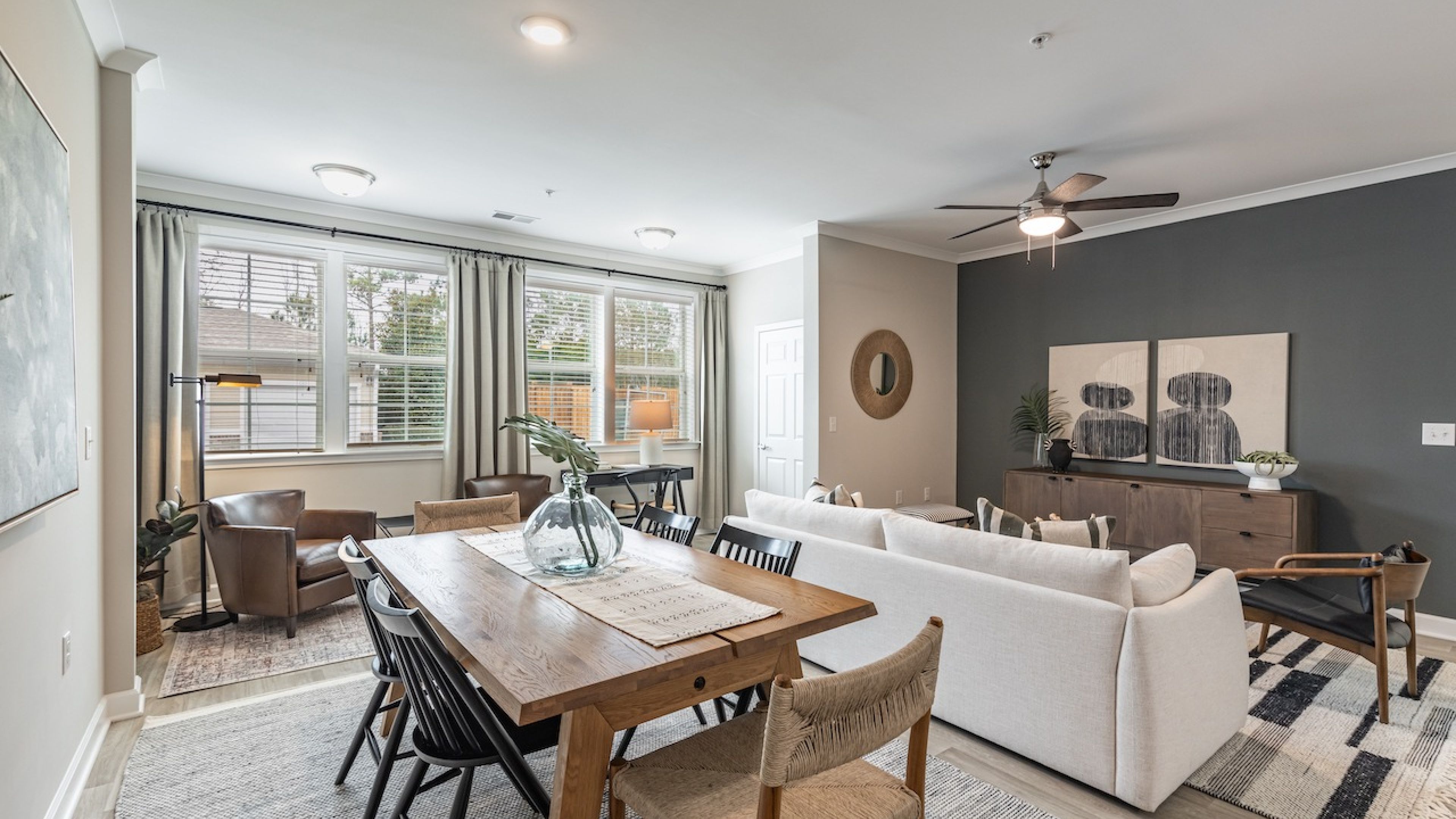 Hawthorne at Stillwater apartment living space and kitchen with small dining table, kitchen peninsula, and stainless steel appliances