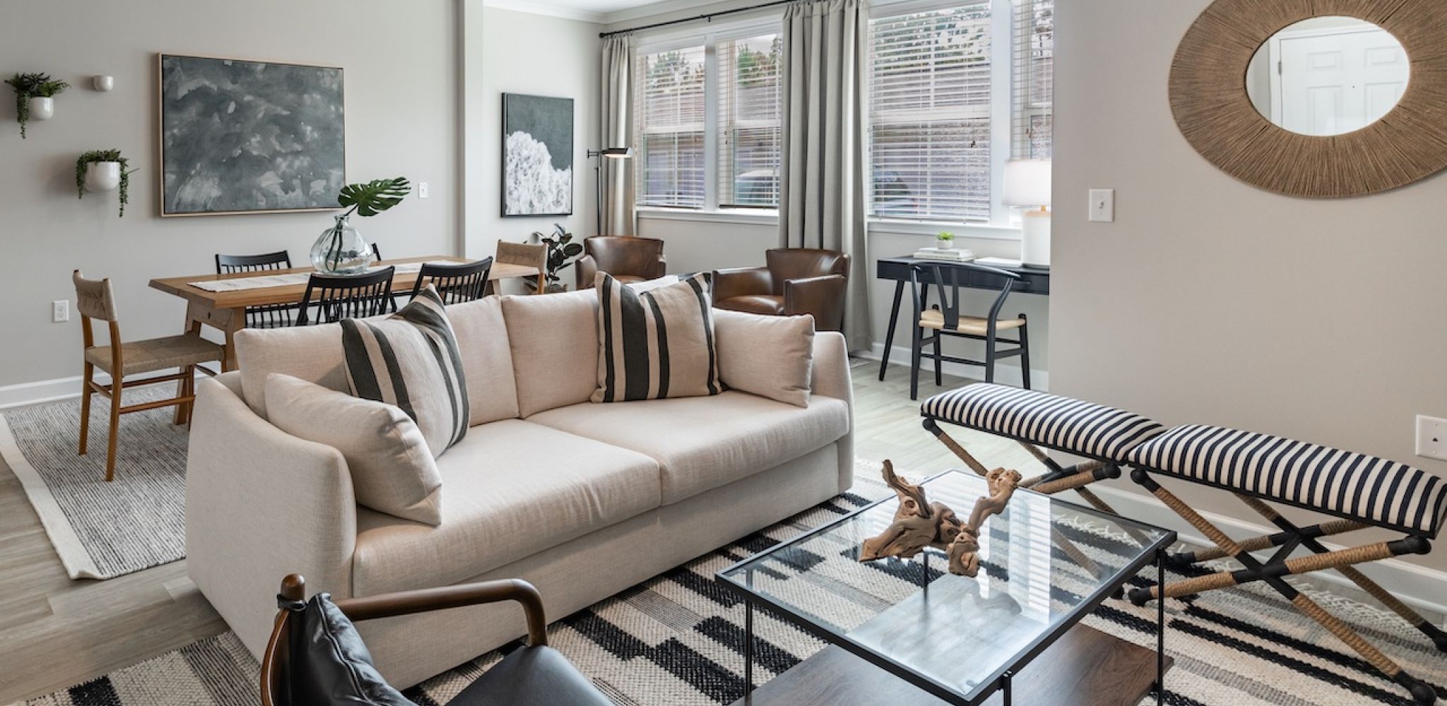 Chic living room leading to a kitchen breakfast bar at Hawthorne at Stillwater apartments, showcasing the spacious interiors in Sneads Ferry.